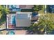 Aerial view showing home with solar panels, pool, and screened enclosure at 1511 Oak Hill Trl, Kissimmee, FL 34747