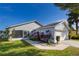 Gray house with white garage door and landscaping at 1511 Oak Hill Trl, Kissimmee, FL 34747