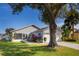 Gray house with white garage door and landscaping at 1511 Oak Hill Trl, Kissimmee, FL 34747