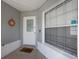 Front porch with white door and a window at 1511 Oak Hill Trl, Kissimmee, FL 34747
