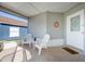 Screened porch with white chairs and a welcome mat at 1511 Oak Hill Trl, Kissimmee, FL 34747