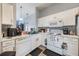 White kitchen with appliances and mosaic backsplash at 1511 Oak Hill Trl, Kissimmee, FL 34747