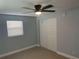 Well-lit bedroom with ceiling fan and sliding closet doors at 1750 S Palmetto Ave # 300, Daytona Beach, FL 32119