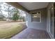 Covered back patio with pavers, overlooking a grassy backyard and trees at 223 Cherokee Hill, Deland, FL 32724