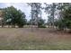 Spacious backyard with mature trees and grassy areas at 223 Cherokee Hill, Deland, FL 32724