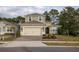 Two-story house with gray siding, a two-car garage, and landscaping at 223 Cherokee Hill, Deland, FL 32724