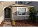Front entry with dark-stained door and sidelights, brick walkway at 223 Cherokee Hill, Deland, FL 32724