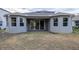 Rear view of house showcasing covered patio at 223 Cherokee Hill, Deland, FL 32724