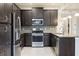 Modern kitchen with dark cabinets, stainless steel appliances, granite counters at 223 Cherokee Hill, Deland, FL 32724