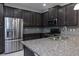 Modern kitchen with dark cabinets, stainless steel appliances, granite counters at 223 Cherokee Hill, Deland, FL 32724