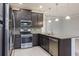 Modern kitchen with dark cabinets, stainless steel appliances, granite counters at 223 Cherokee Hill, Deland, FL 32724