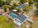 Aerial view of property showing pool, screened enclosure, and detached garage at 2711 W Highland Ave, Apopka, FL 32712