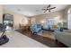 Living room with light walls, hardwood floor, and blue couches at 33931 Terragona Dr, Sorrento, FL 32776