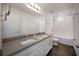 Bathroom with double vanity, shower/tub combo, and grey floor at 3439 Feathergrass Ct, Harmony, FL 34773