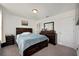 Main bedroom with a large bed and built-in drawers at 3439 Feathergrass Ct, Harmony, FL 34773