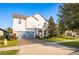 Two-story house with gray siding, paver driveway, and landscaping at 3439 Feathergrass Ct, Harmony, FL 34773