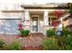 Two-story house exterior with gray front door and brick walkway at 3439 Feathergrass Ct, Harmony, FL 34773