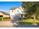 Two-story house exterior with gray siding and a gray garage door at 3439 Feathergrass Ct, Harmony, FL 34773