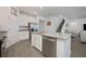 Modern kitchen with white cabinets, stainless steel appliances and island at 3439 Feathergrass Ct, Harmony, FL 34773