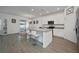 Kitchen features white cabinets, an island, and stainless steel appliances at 3439 Feathergrass Ct, Harmony, FL 34773