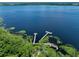 Aerial view of community lakefront with two wooden piers at 3439 Feathergrass Ct, Harmony, FL 34773
