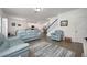 Living room with light blue reclining sofas and a large TV at 3439 Feathergrass Ct, Harmony, FL 34773