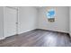 Bright bedroom featuring wood-look floors and a door at 3482 Forster Ave, Leesburg, FL 34748