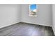 Simple bedroom with gray floors and a window at 3482 Forster Ave, Leesburg, FL 34748