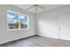 Spacious bedroom with large window, ceiling fan, and wood-look floors at 3482 Forster Ave, Leesburg, FL 34748