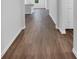 Bright hallway with dark brown wood-look flooring at 3482 Forster Ave, Leesburg, FL 34748