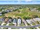 Aerial view of the neighborhood, golf course, and houses in a well-maintained community at 5024 St Andrews Arc, Leesburg, FL 34748