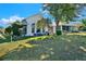 Expansive backyard showcasing a well-maintained lawn, lush greenery, and a charming outdoor patio area at 5024 St Andrews Arc, Leesburg, FL 34748