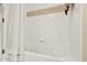 Clean, white bathtub with tiled walls and simple fixtures, offering a serene bathing experience at 5024 St Andrews Arc, Leesburg, FL 34748