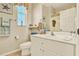 Well-lit bathroom featuring a white vanity, decorative coastal accents, and ample counter space at 5024 St Andrews Arc, Leesburg, FL 34748