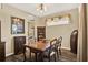 Cozy dining room with a wooden dining table, decorative window, and an adjacent kitchen view at 5024 St Andrews Arc, Leesburg, FL 34748
