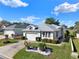 Charming single-story home featuring a two-car garage, mature landscaping, and a well-maintained lawn at 5024 St Andrews Arc, Leesburg, FL 34748