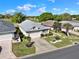 Desirable single-story home with two-car garage, lush landscaping, and well-kept lawn in a golf community at 5024 St Andrews Arc, Leesburg, FL 34748