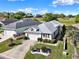 Inviting single-story home with a two-car garage, green lawn and landscaping, near a golf course at 5024 St Andrews Arc, Leesburg, FL 34748