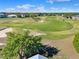 Aerial view of the golf course, with its lush green fairways, manicured greens and scenic sand traps at 5024 St Andrews Arc, Leesburg, FL 34748