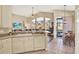 Open concept kitchen with views to the living area and a casual dining space with golf course view at 5024 St Andrews Arc, Leesburg, FL 34748