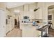 Bright kitchen featuring white cabinets, a breakfast bar, and an open layout, perfect for modern living at 5024 St Andrews Arc, Leesburg, FL 34748