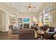 Spacious living room with vaulted ceiling, comfortable seating, and a view into the adjacent bedroom at 5024 St Andrews Arc, Leesburg, FL 34748
