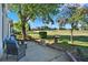 Inviting patio with comfortable seating, surrounded by lush greenery and a scenic view of the community at 5024 St Andrews Arc, Leesburg, FL 34748