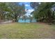 Large backyard with mature trees and a partially fenced area at 514 S Crystal Lake Dr, Orlando, FL 32803