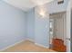 Bedroom with light blue walls, tile floors and access to bathroom at 514 S Crystal Lake Dr, Orlando, FL 32803