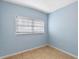 Light blue bedroom with tile floor and window blinds at 514 S Crystal Lake Dr, Orlando, FL 32803