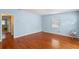 Hardwood floor bedroom with light blue walls and a window at 514 S Crystal Lake Dr, Orlando, FL 32803