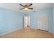 Light blue bedroom with tiled floors and ceiling fan at 514 S Crystal Lake Dr, Orlando, FL 32803