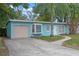 Cute light blue house with a beige garage and a brick walkway at 514 S Crystal Lake Dr, Orlando, FL 32803