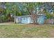 Ranch style home with a light blue exterior, palm trees, and a walkway at 514 S Crystal Lake Dr, Orlando, FL 32803
